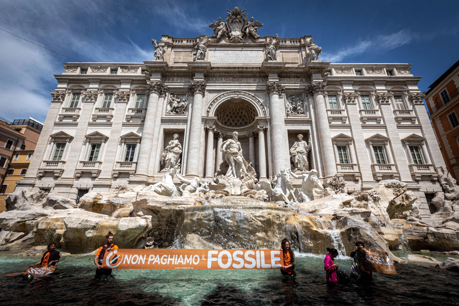 Climate activists from the group 'Last Generation' stand inside the Trevi Fountain in Rome, Italy, 21 May 2023. About a dozen activists, who recalled the emergency in the Italian region of Emilia-Romagna, where about 30,000 people have been displaced after heavy floods in recent days, threw a black liquid, vegetable charcoal, into the famed Trevi fountain with banners reading 'let's not pay for fossils' and shouting 'our country is dying'. Local police intervened on the spot.
ANSA/STRINGER