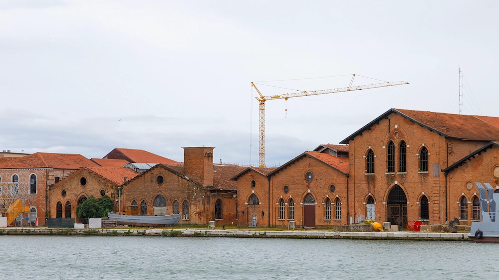 Industrial shipyards (Arsenale di Venezia) in Italy, Venice. Loading cranes and docks.