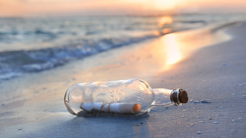 Messaggio in bottiglia sulla riva del mare