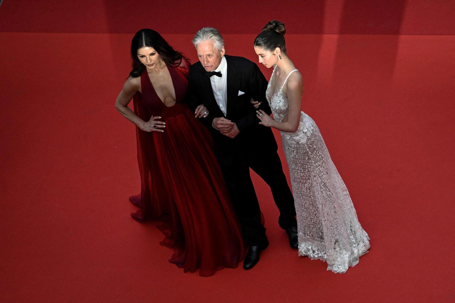 US actor and Honorary Palme d’or of the 76th Festival de Cannes Michael Douglas (C) arrives with his wife British actress Catherine Zeta-Jones (L) and daughter Carys for the opening ceremony and the screening of the film "Jeanne du Barry" during the 76th edition of the Cannes Film Festival in Cannes, southern France, on May 16, 2023. (Photo by Patricia Moreira / AFP)
