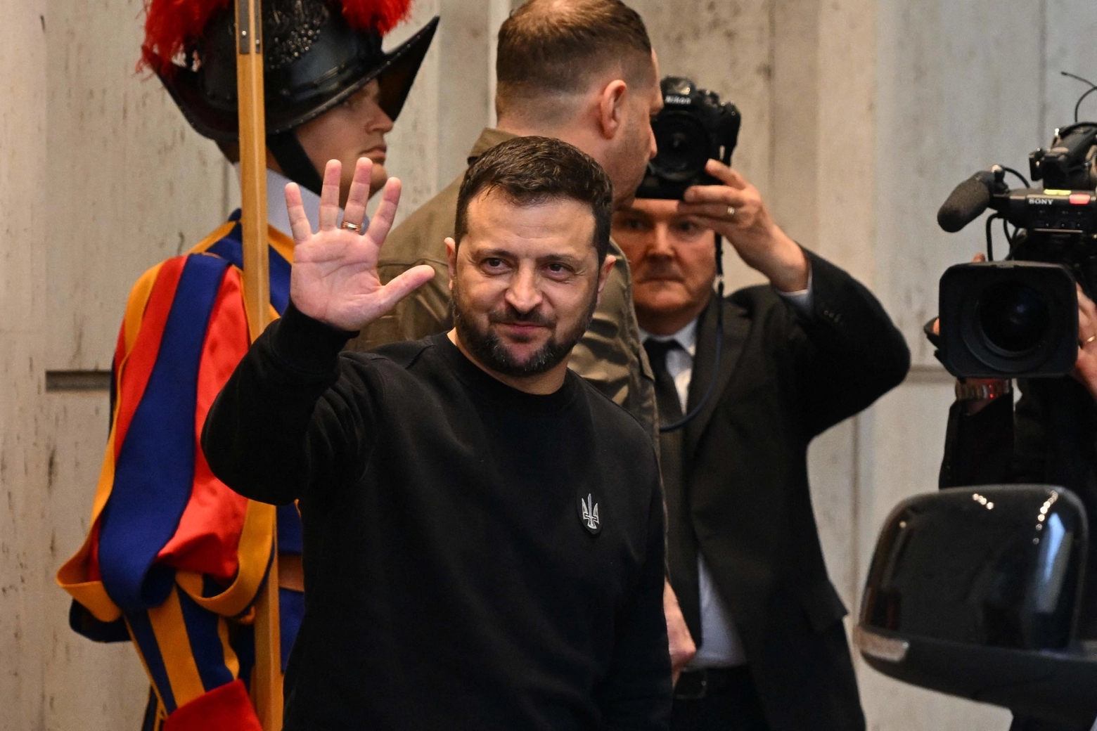 Ukrainian President Volodymyr Zelensky waves as he leaves following a private audience with the Pope on May 13, 2023 in The Vatican. Ukrainian President Volodymyr Zelensky arrived in Rome on May 13 for meetings with President of Italy Sergio Mattarella, Prime Minister Giorgia Meloni and Pope Francis in his first visit to Italy since Russia's invasion. (Photo by Andreas SOLARO / AFP)