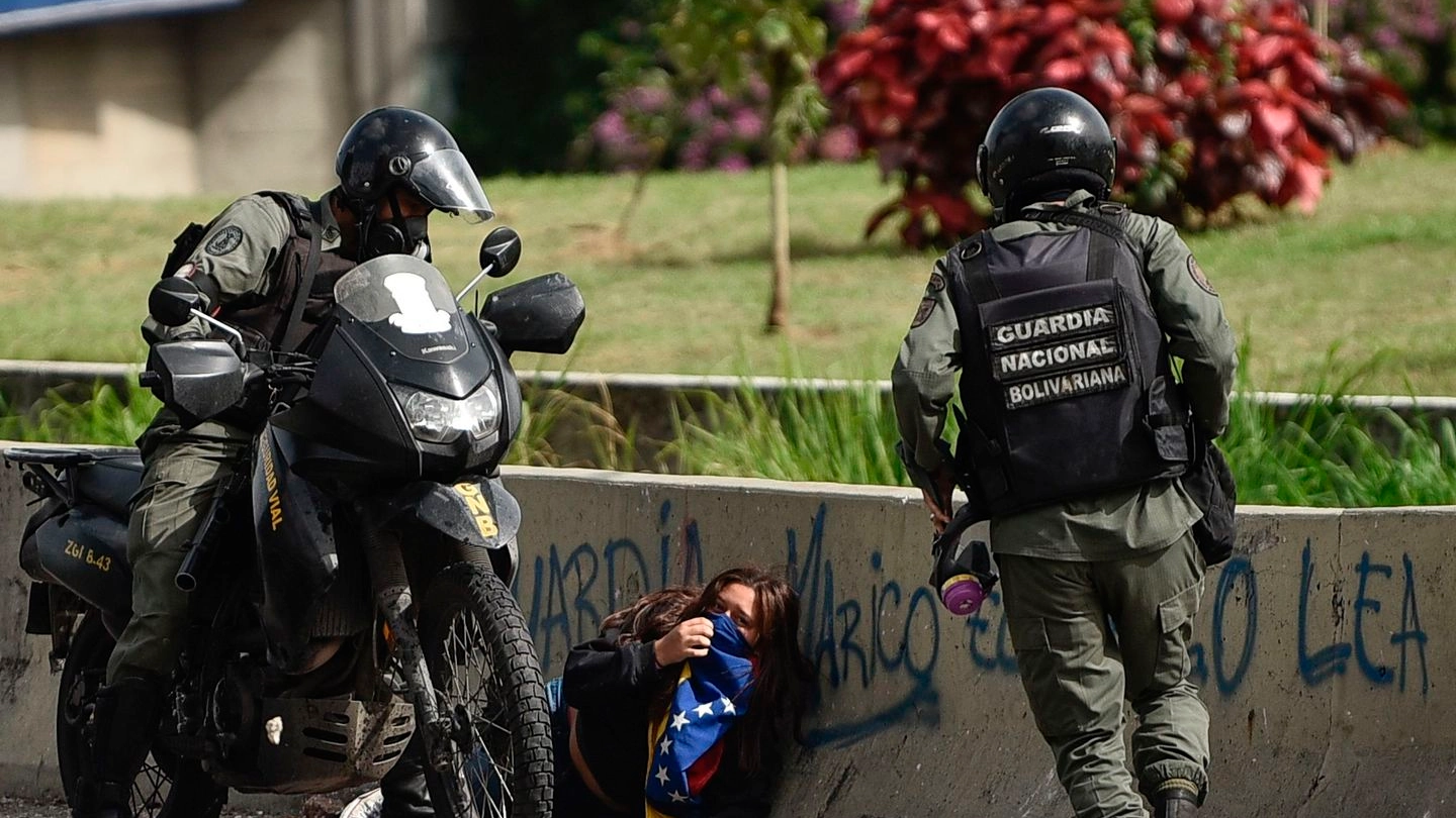La Guardia Nazionale venezuelana blocca una manifestante (Afp)