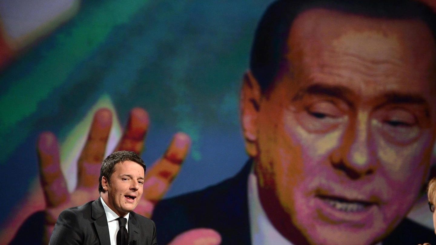 Matteo Renzi e, sullo sfondo, un'immagine di Silvio Berlusconi (Ansa)