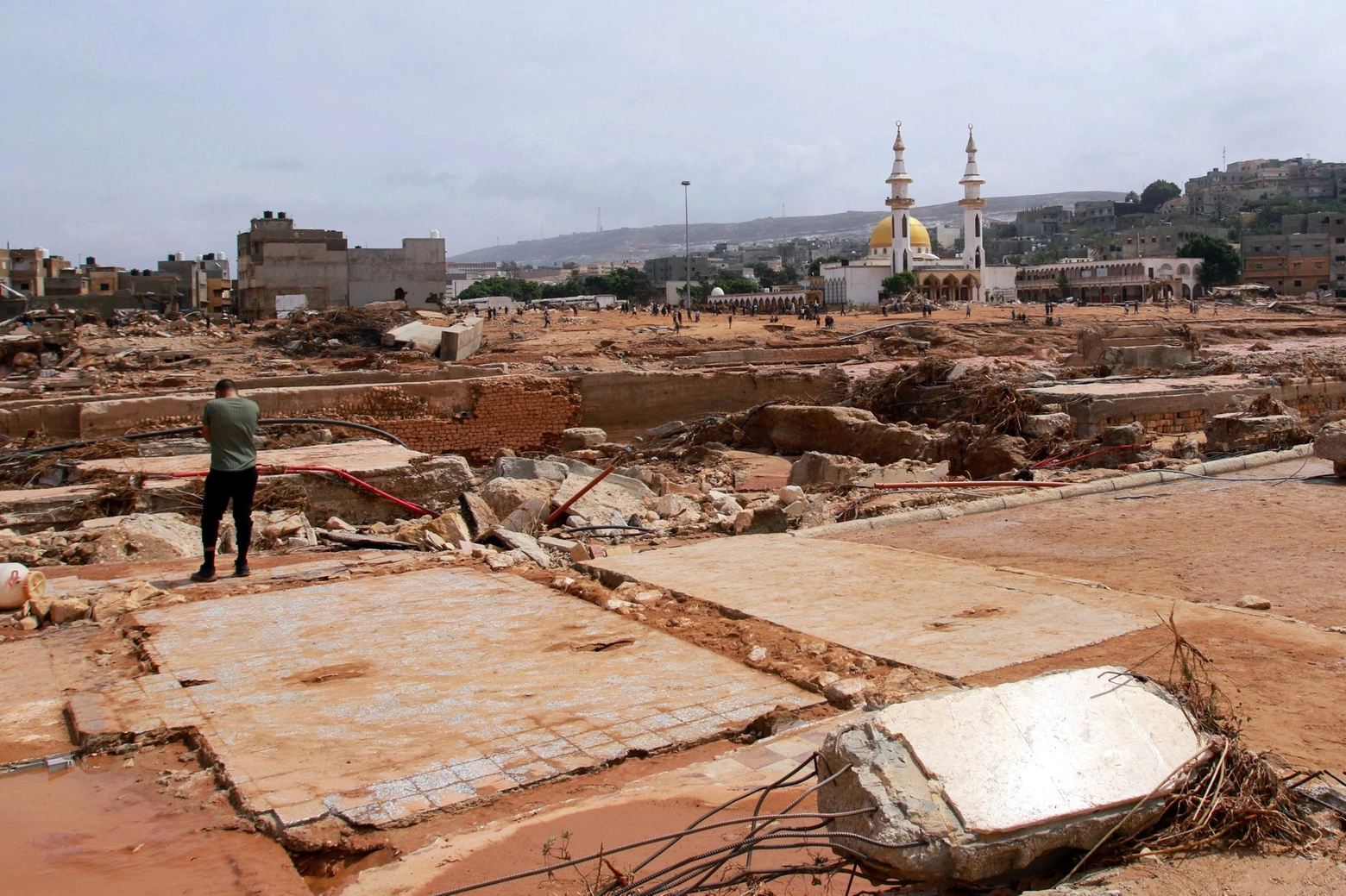 A man looks at the damage caused by freak floods in Derna, eastern Libya, on September 11, 2023. The death toll from freak floods in eastern Libya is expected to soar dramatically, with 10,000 people reported missing, the Red Cross warned on September 12. Officials in Libya have said at least 150 people were killed in the sudden flooding on Sunday afternoon after storm Daniel swept the Mediterranean, lashing Bulgaria, Greece and Turkey. (Photo by AFP)