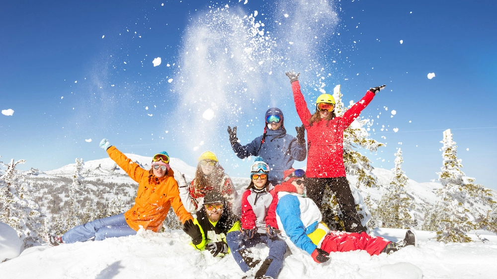 Happy skiers and snowboarders winter vacations