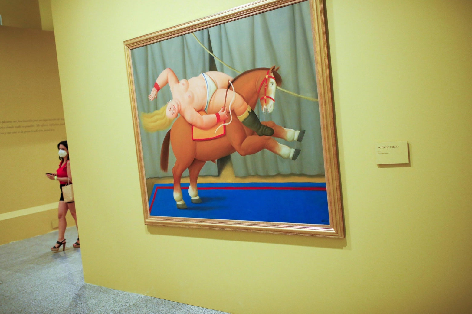 epa08672592 A visitor passes next to the painting 'Acto de Circo' (Lit: Circus Act) by Colombian artist Fernando Botero during the press preview of the Exhibition 'Botero: 60 Years of Painting' at CentroCentro in Madrid, Spain, 16 September 2020. The show features 67 artworks by Botero and will run from 17 September 2020 to 07 February 2021.  EPA/David Fernandez