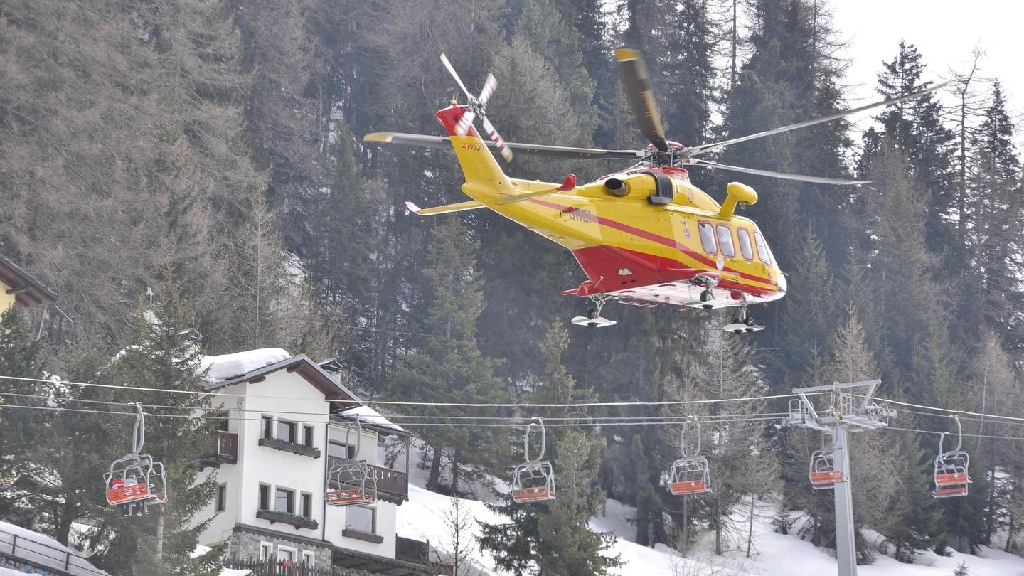 L'elicottero del soccorso alpino in azione dopo la valanga a Pila (Ansa)