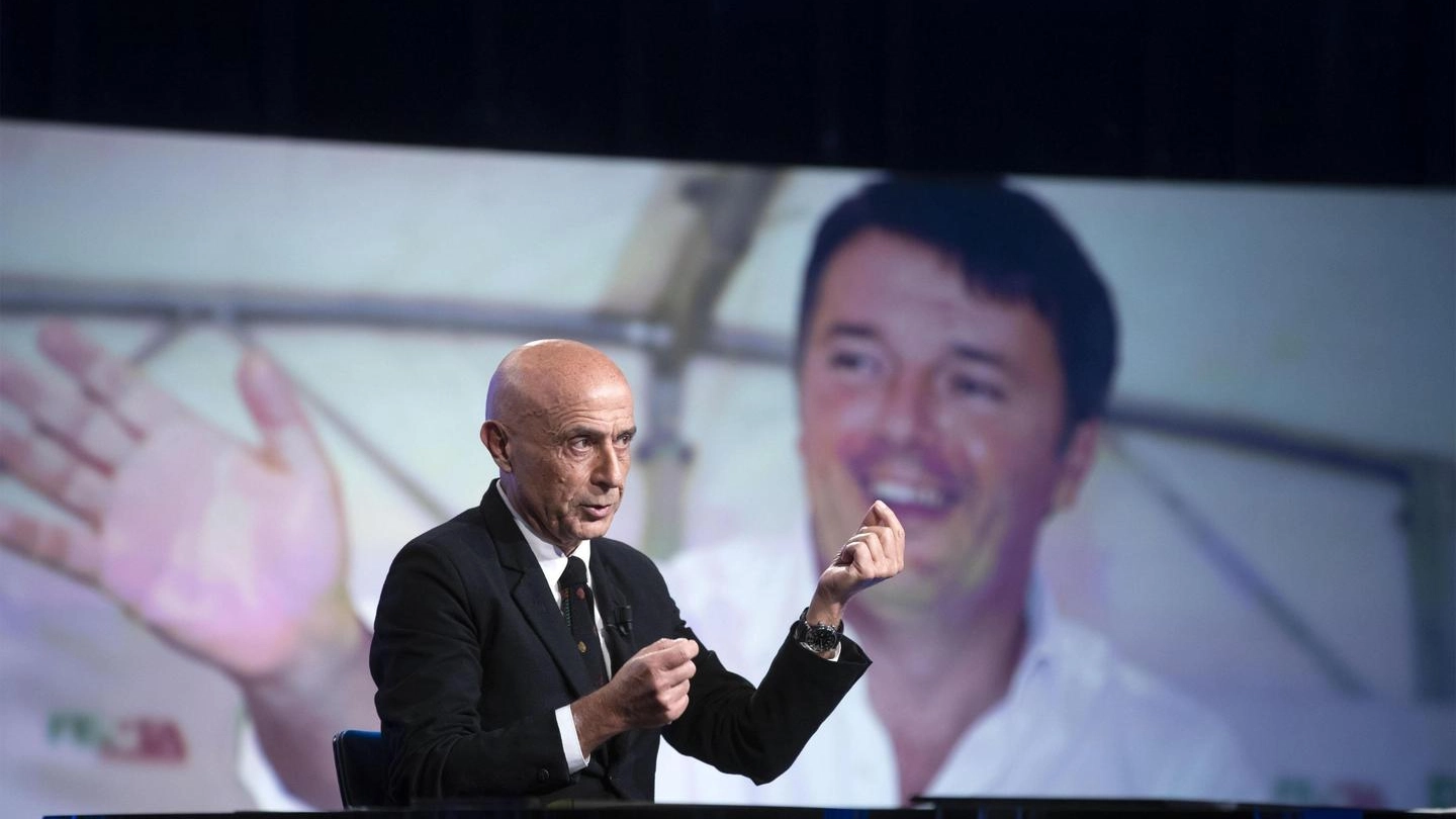 Marco Minniti, alle sue spalle una foto di Matteo Renzi (Ansa)