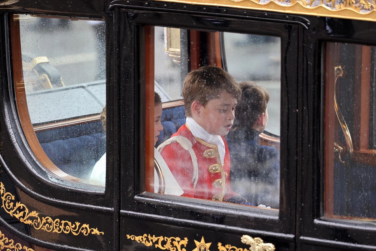 epa10611952 (L-R) Britain's Princess Charlotte, Prince George, and Prince Louis of Wales return to Buckingham Palace following the Coronation ceremony of Britain's King Charles III and Queen Camilla in London, Britain, 06 May 2023. The Coronation Procession in the Gold State Coach will be accompanied by members of the Armed Forces of the United Kingdom, the Commonwealth, British Overseas Territories and the Sovereign's Bodyguard and Royal Watermen.  EPA/Tolga Akmen