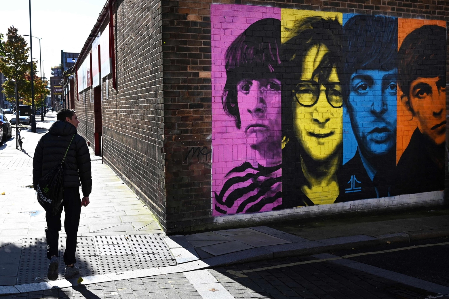 Un murale coi volti dei Beatles su un muro di Liverpool, dove nacque la band (Ansa)