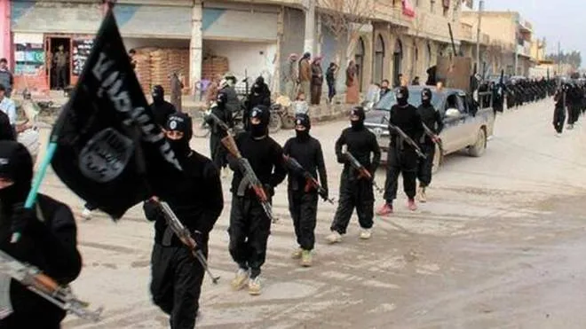 FILE - This undated file image posted on a militant website on Jan. 14, 2014, which has been verified and is consistent with other AP reporting, shows fighters from the Islamic State group marching in Raqqa, Syria. The Islamic States gruesome rampage across the Middle East has united the world in horror but left it divided over how to refer to the group, with observers adopting different acronyms based on their translation of an archaic geographical term and the extent to which they want to needle the group. (ANSA/AP Photo/Militant Website, File)