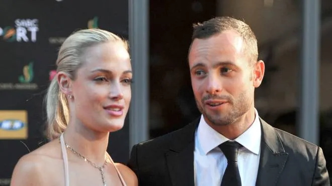 (FILES) This file picture dated November 4, 2012 shows South Africa's Olympic sprint star Oscar Pistorius and his girlfriend Reeva Steenkamp during the Feather Awards held at Melrose Arch in Johannesburg. "Blade Runner" Oscar Pistorius sat weeping in the dock on September 11, 2014 as a judge began handing down the verdict over the Valentine's Day killing of the star Paralympian's model lover. If found guilty of deliberately killing girlfriend Reeva Steenkamp in the early hours of Valentine's Day 2013, he faces a life in South Africa's infamously tough prisons and notoriety that would eclipse his Olympic-sized sporting achievements. AFP PHOTO / Lucky Nxumalo