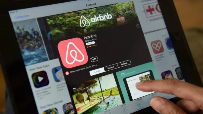 (FILES) This file photo taken on April 28, 2016 shows a woman browsing the site of US home sharing giant Airbnb on a tablet in Berlin on April 28, 2016.
Barcelona city hall said on November 24, 2016 it would fine home rental websites Airbnb and rival HomeAway 600,000 euros ($635,000) each for marketing lodgings that lacked permits to host tourists. The fine comes as the popular seaside resort struggles with a rising tide of tourism that has exasperated locals, threatening to drive out poorer residents and spoil the charm of Spain's second-largest city.
 / AFP PHOTO / John MACDOUGALL