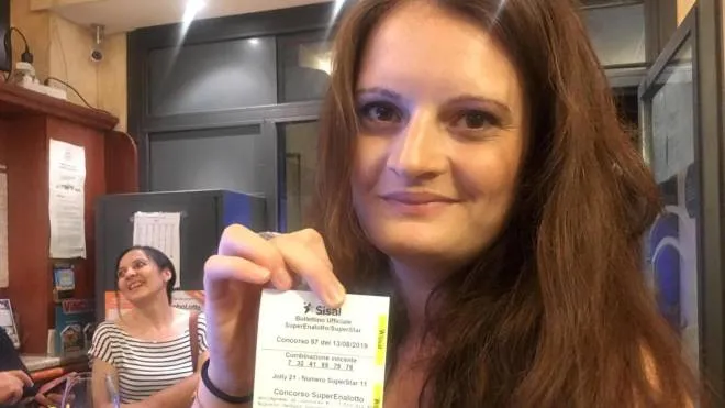 The owner of the Marino?s bar, Sara Poggi, shows the receipt of the ticket where it was bet the winning ticket of the "SuperEnalotto" in Lodi, Italy, 13 August 2019. The value of the winnings is 209 million euro.
ANSA/LAURA GOZZINI