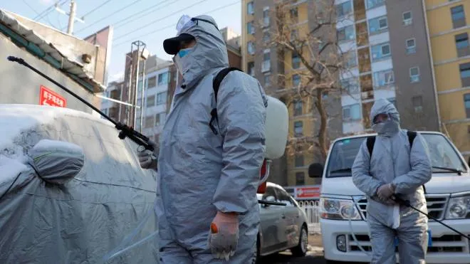 epa08219076 Workers wearing protective suits disinfect a residential area in Beijing, China, 15 February 2020. Beijing officials ordered everyone returning to the city after the holidays to go into quarantine for 14 days in order to control the spread of coronavirus. The disease caused by the novel coronavirus (SARS-CoV-2) has been officially named COVID-19 by the World Health Organization (WHO). The outbreak, which originated in the Chinese city of Wuhan, has so far killed at least 1,526 people with over 67,000 infected worldwide, mostly in China.  EPA/WU HONG