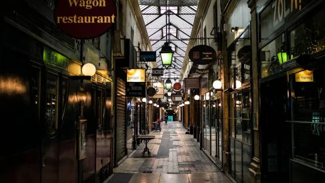 epa08298253 Shops and restaurant are closed in an empty covered passage of Panoramas on the day 2 of the measures to contain the spread of coronavirus SARS-CoV-2 which causes the Covid-19 disease, in Paris, France, 16 March 2020. French Prime Minister Edouard Philippe announced on 14 March 2020 that all places that are not essential to French living, including restaurants, cafes, cinemas and clubs, will be closed from 15 March 2020 until further notice. President Macron announced the closing of schools, high schools and nurseries from 16 March 2020 on.  EPA/YOAN VALAT