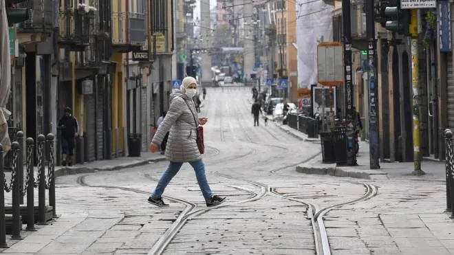 The  medieval Ticinese gate is seen as a woman walk a deserted road due to the nationwide lockdown mesures, Milan, Italy, 27 March 2020.Countries around the world take measures to stem the widespread of the SARS-CoV-2The coronavirus which causes the Covid-19 disease. ANSA/DANIEL DAL ZENNARO