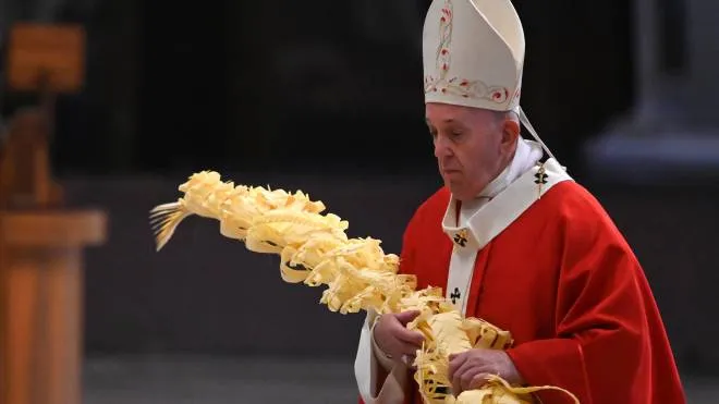Pope Francis holds a palm branch as he celebrates Palm Sunday behind closed doors in St. Peter's Basilica mass on April 5, 2020 in The Vatican, during the lockdown aimed at curbing the spread of the COVID-19 infection, caused by the novel coronavirus. (Photo by Alberto PIZZOLI / POOL / AFP)