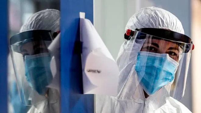Doctors and nurses wear protective equipment in the COVID-3 level intensive care unit, treating COVID-19 patients, at the Casal Palocco hospital near Rome, Italy, 22 April 2020. ANSA/ANGELO CARCONI
