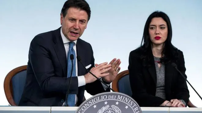 Italian Prime Minister Giuseppe Conte (L) with Italian Education Minister Lucia Azzolina (R) during a press conference about Italy's coronavirus emergency situation at Chigi palace, Rome, 04 March 2020. The government has decided to close schools and universities until mid-March to reduce the risk of contagion of the coronavirus.  ANSA/ANGELO CARCONI