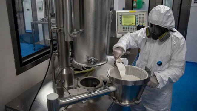 epa08508737 An employee wears a full-face mask and a protective suit while working at the laboratories of the Eva Pharma company in Cairo, Egypt, 25 June 2020. The Egyptian drugmaker has reached a landmark deal with US company Gilead Sciences Inc. licensing the former to manufacture Gilead's antiviral drug remdesivir � an experimental treatment for patients suffering from the pandemic COVID-19 disease caused by the SARS-CoV-2 coronavirus � and distribute it in 127 countries.  EPA/MOHAMED HOSSAM