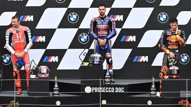 (LtoR) Second placed Pramac Racing's Australian rider Jack Miller, winner Red Bull KTM Tech 3's Portuguese rider Miguel Oliveira and third placed Red Bull KTM Factory Racing's Spanish rider Pol Espargaro celebrate on the podium after winning the MotoGP Styrian Grand Prix on August 23, 2020 at Red Bull Ring circuit in Spielberg bei Knittelfeld, Austria. (Photo by Joe Klamar / AFP)