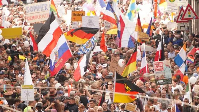 epa08633145 Demonstrators with various flags of Germany, Russia, Netherlands, German Empire and Bavaria protest against coronavirus pandemic regulations in Berlin, Germany, 29 August 2020. The initiative 'Querdenken 711' and an alliance of right wing groups have called to demonstrate against coronavirus regulations like face mask wearing, in Berlin. Meanwhile forbidden, Berlin administrative court and higher administrative court allowed the demonstration to take place under certain requirements. Police announced to stop the demonstration when conditions were not met.  EPA/CLEMENS BILAN