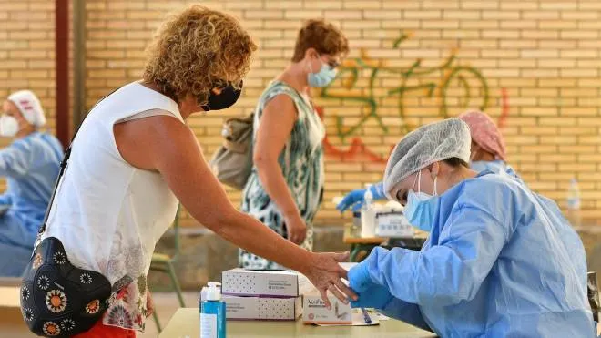 epa08641162 A health worker runs a quick coronavirus test on a teacher in Almeria, Spain, where hundreds of school teachers took the tests before the start of the school year, 02 Sepember 2020. A total of 13,500 teachers will be tested in Andalucia region before returning to the classrooms.  EPA/Carlos Barba
