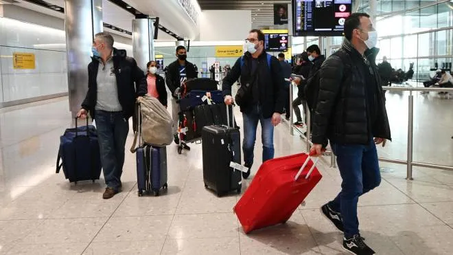 epa08989065 Travellers arrive at Heathrow Airport in London, Britain, 05 February 2021. The UK government is set to implement stricter measures for travellers arriving at Heathrow from Monday 15 February 2021. People arriving into Heathrow from so called 'at risk' countries will have to isolate in designated government hotels for up to ten days at their own cost.  EPA/ANDY RAIN