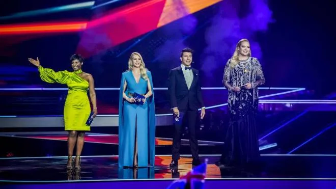 epa09216222 (L-R) Presenters Edsilia Rombley, Chantal Janzen, Jan Smit and Nikkie de Jager host during the Second Semi-Final of the 65th annual Eurovision Song Contest (ESC) at the Rotterdam Ahoy arena, in Rotterdam, The Netherlands, 20 May 2021. Due to the coronavirus (COVID-19) pandemic, only a limited number of visitors is allowed at the 65th edition of the Eurovision Song Contest (ESC2021) that is taking place in an adapted form and consist of two semi-finals, on 18 and 20 May, and a grand final on 22 May.  EPA/SANDER KONING / POOL *** Local Caption *** 50359766