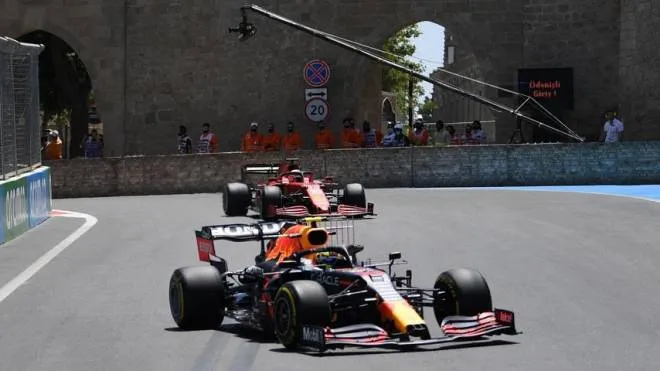 Red Bull's Mexican driver Sergio Perez and Ferrari's Monegasque driver Charles Leclerc steer their cars during the first practice session ahead of the Formula One Azerbaijan Grand Prix at the Baku City Circuit in Baku on June 4, 2021. (Photo by OZAN KOSE / AFP)