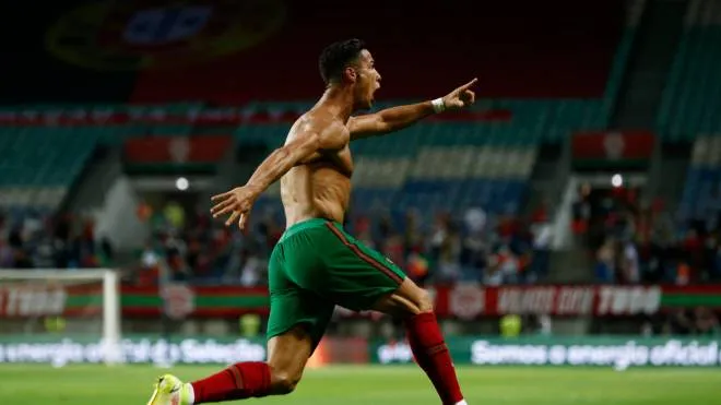 epa09441704 Cristiano Ronaldo of Portugal celebrates after scoring a goal during the FIFA World Cup Qatar 2022 group A qualification soccer match between Portugal and Ireland held at Algarve stadium in Faro, Portugal, 01 September  2021.  EPA/ANTONIO COTRIM