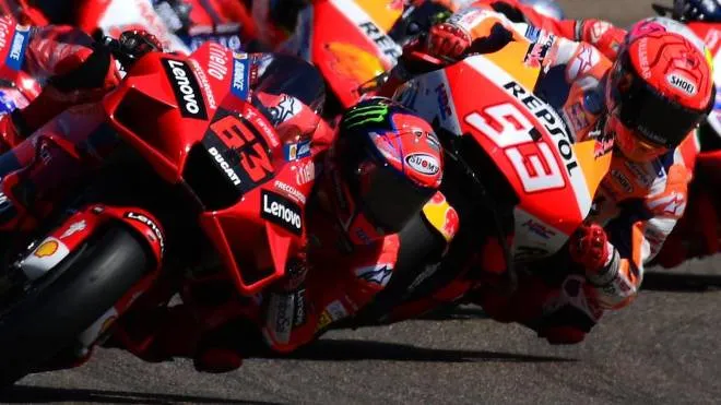 Ducati Italian rider Francesco Bagnaia (L) leads the pack ahead of Honda Spanish rider Marc Marquez during the Moto Grand Prix of Aragon at the Motorland circuit in Alcaniz on September 12, 2021. (Photo by LLUIS GENE / AFP)