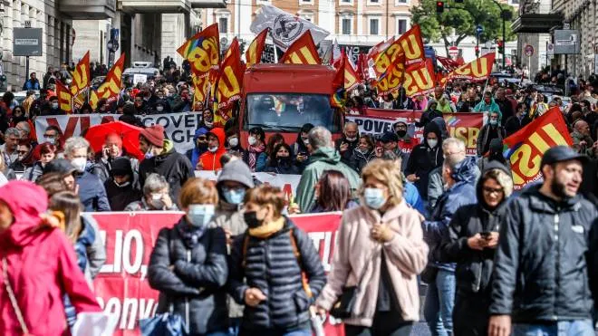 Demonstrators with banners and flags during the Cobas demonstration against the Draghi government in Rome, Italy, 11 October 2021.ANSA/FABIO FRUSTACI