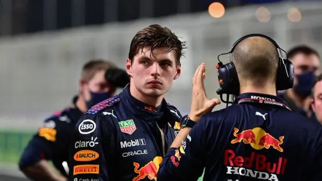 Red Bull's Dutch driver Max Verstappen (L) speaks with team members  during a second stop in the session of the Formula One Saudi Arabian Grand Prix at the Jeddah Corniche Circuit in Jeddah on December 5, 2021. (Photo by ANDREJ ISAKOVIC / various sources / AFP)