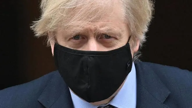 (FILES) In this file photo taken on March 03, 2021 Britain's Prime Minister Boris Johnson, wearing a protective face covering to combat the spread of the coronavirus, leaves 10 Downing Street in central London, to take part in the weekly session of Prime Minister Questions (PMQs) at the House of Commons. - Boris Johnson on December 14, 2021, faces a backlash from his own MPs in parliament about new coronavirus restrictions, as he battles a slump in support and questions about his future. (Photo by JUSTIN TALLIS / AFP)