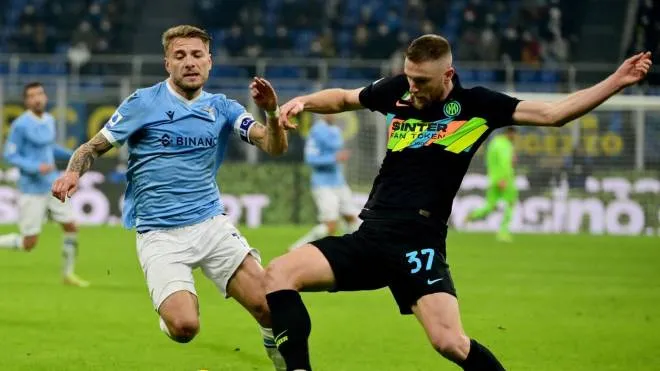Lazio's Italy's forward Ciro Immobile (L) fights for the ball with with Inter Milan's Slovakian defender Milan Skriniar during the Serie A football match beetween Inter Milan and Lazio at the Meazza stadium in Milan on January 9, 2022. (Photo by MIGUEL MEDINA / AFP)