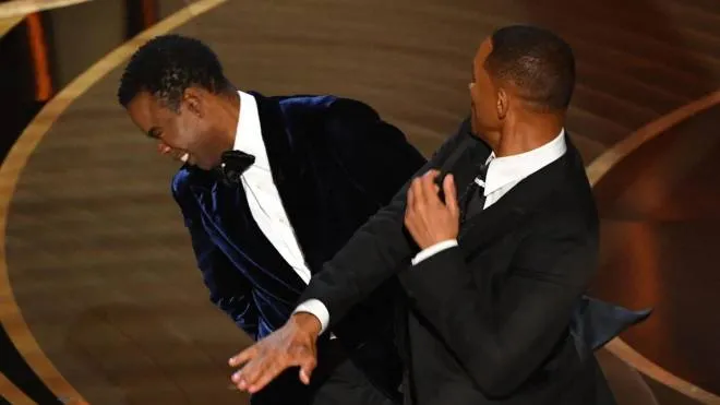 US actor Will Smith (R) slaps US actor Chris Rock speaks onstage during the 94th Oscars at the Dolby Theatre in Hollywood, California on March 27, 2022. (Photo by Robyn Beck / AFP)
