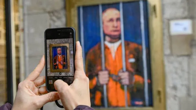 Barcellona: uno smartphone per scattare le immagini di una nuova opera dello street artist italiano TvBoy che ritrae il presidente russo Putin in prigione
