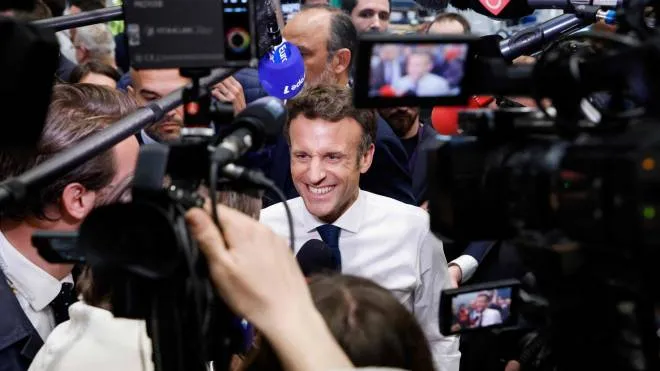 French President and liberal party La Republique en Marche (LREM) candidate for re-election Emmanuel Macron smiles as he speaks to the press during a visit at the Siemens Gamesa's factory, which produces wind turbines, in Le Havre, northwestern France, on April 14, 2022 as part of a one-day campaign visit, ten days ahead of the second round of the French presidential election. (Photo by Ludovic MARIN / AFP)