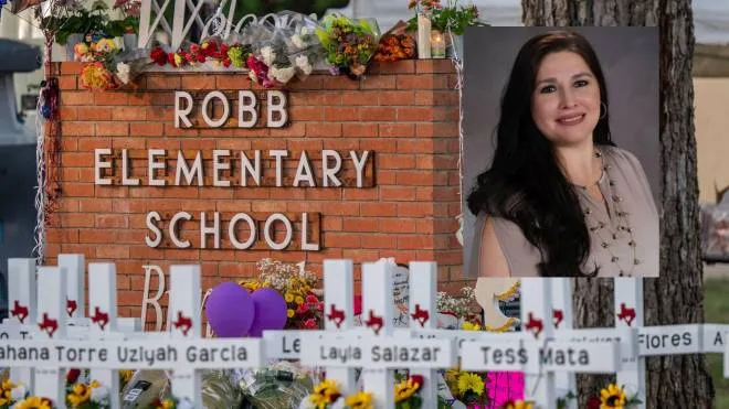 UVALDE, TEXAS - MAY 26: A memorial is seen surrounding the Robb Elementary School sign following the mass shooting at Robb Elementary School on May 26, 2022 in Uvalde, Texas. According to reports, 19 students and 2 adults were killed, with the gunman fatally shot by law enforcement.   Brandon Bell/Getty Images/AFP
== FOR NEWSPAPERS, INTERNET, TELCOS & TELEVISION USE ONLY ==