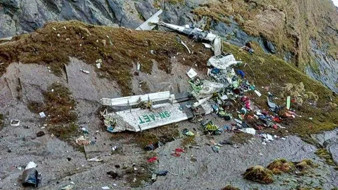 The wreckage of a Twin Otter aircraft, operated by Nepali carrier Tara Air, lay on a mountainside in Mustang on May 30, 2022, a day after it crashed. - Nepali rescuers pulled 14 bodies on May 30 from the mangled wreckage of a passenger plane strewn across a mountainside that went missing in the Himalayas with 22 people on board. (Photo by Bishal MAGAR / AFP)