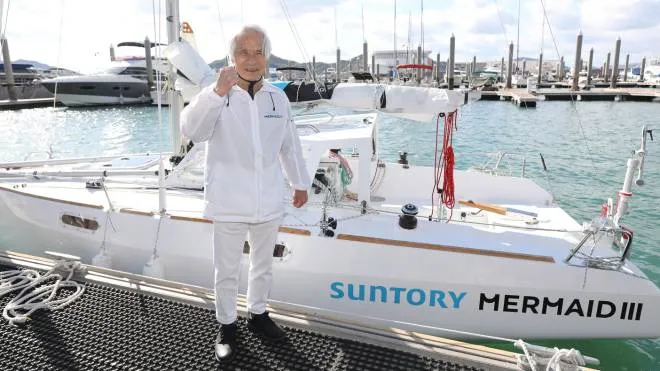 Kenichi Horie? a Japanese yachtsman, poses for a photo in front of his new yacht, Suntory Mermaid III, in Onomichi City, Hiroshima Prefecture on Nov. 27, 2021, The launching ceremony of the yacht was held on the same day. 83 year-old Horie has a plan of a solo-sail across the Pacific Ocean without a port call as the oldest in the world in next March. ( The Yomiuri Shimbun ) (Photo by Takuya Yoshino / Yomiuri / The Yomiuri Shimbun via AFP)