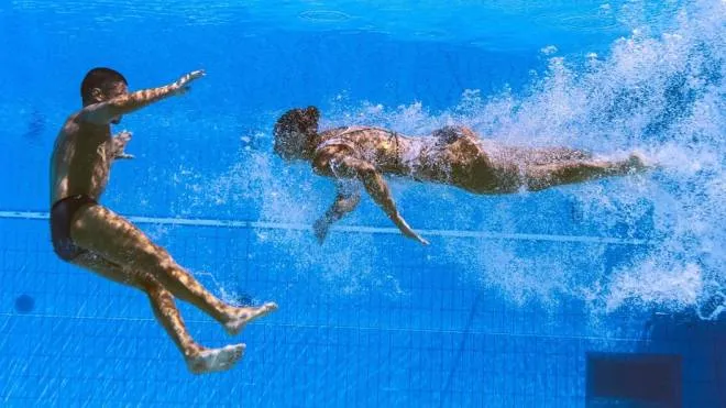Italy's Giorgio Minisini and Italy's Lucrezia Ruggiero competes to take gold in the mixed duet free artistic swimming finals during the Budapest 2022 World Aquatics Championships at the Alfred Hajos Swimming Complex in Budapest on June 25, 2022. (Photo by Fran�ois-Xavier MARIT / AFP)