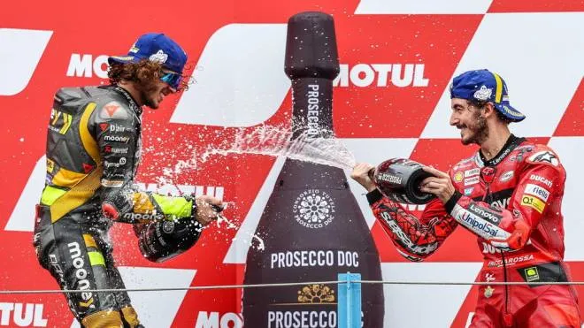 epa10035206 Francesco Bagnaia of Italy (R) of the Ducati Lenovo Team celebrates on the podium winning the MotoGP race of the Motorcycling Grand Prix of the Netherlands with his compatriot and second placed Marco Bezzecchi at the TT circuit of Assen, Netherlands, 26 June 2022.  EPA/Vincent Jannink