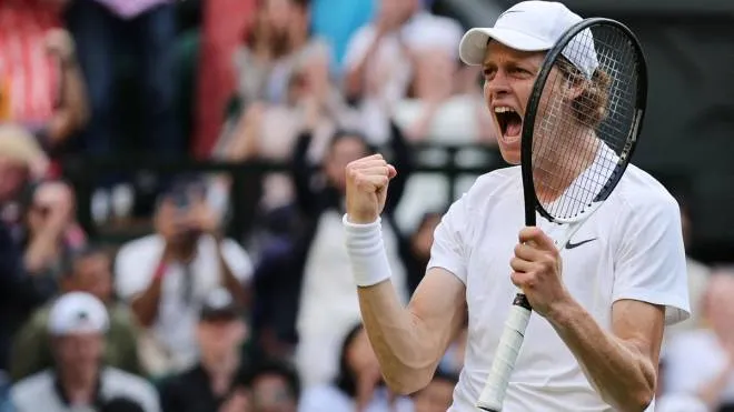 Italy's Jannik Sinner celebrates beating Spain's Carlos Alcaraz during their round of 16 men's singles tennis match on the seventh day of the 2022 Wimbledon Championships at The All England Tennis Club in Wimbledon, southwest London, on July 3, 2022. (Photo by Adrian DENNIS / AFP) / RESTRICTED TO EDITORIAL USE