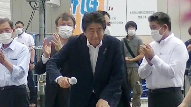 epa10058674 Former Japanese Prime Minister Shinzo Abe (C) steps up to podium to speak to voters in support of his party's candidate during an Upper House election campaign outside Yamato-Saidaiji Station of Kintetsu Railway in Nara, western Japan, 08 July 2022, just before he was shot. The suspect Tetsuya Yamagami (2-R), 41, who was arrested by police, is standing behind of Abe as Abe starts to speak.  EPA/JIJI PRESS JAPAN OUT EDITORIAL USE ONLY/