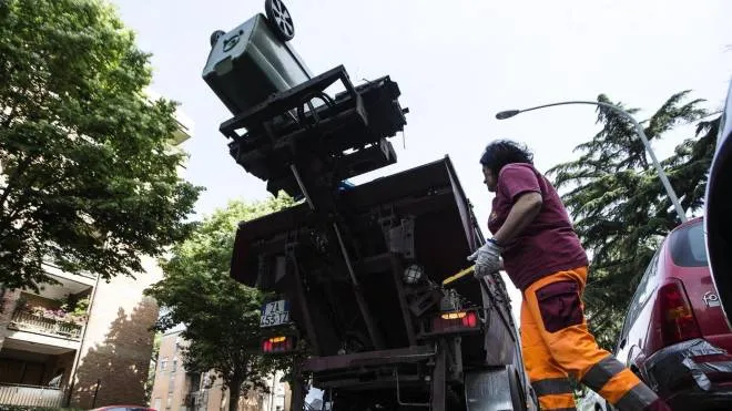 Operatori dell'Ama a lavoro per la pulizia delle strade, servizio portata a porta e svuotamento dei contenitori dei rifiuti all'Eur, 12 maggio 2017. ANSA/ANGELO CARCONI