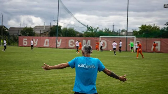 FSC Mariupol's coach reacts during warming-up match against FC Nyva at a tiny Demydiv village stadium 20 kilometres north of Kyiv, on August 20, 2022. - The Russian invasion - that began on February 24 - put a Mariupol football club through the ordeal as their players fled the devastatingly bombed city with no thought of the game. Six months later and hundreds of kilometres away from their home base in a port hub on the Sea of Azov, FSC Mariupol are reassembled and intend to start a new Ukrainian football season. (Photo by Dimitar DILKOFF / AFP)