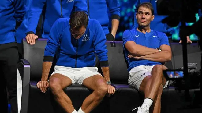 Switzerland's Roger Federer (L) sheds a tear after playing his final match, a doubles with Spain's Rafael Nadal (R) of Team Europe against USA's Jack Sock and USA's Frances Tiafoe of Team World in the 2022 Laver Cup at the O2 Arena in London, early on September 24, 2022. - Roger Federer brings the curtain down on his spectacular career in a "super special" match alongside long-time rival Rafael Nadal at the Laver Cup in London on Friday. (Photo by Glyn KIRK / AFP) / RESTRICTED TO EDITORIAL USE